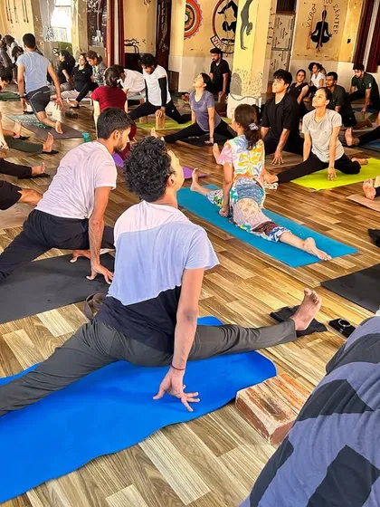A class full of students working on Hanumanasana (front splits) and other hip-opening poses. This shows the collective energy and focus of our teacher training batches.