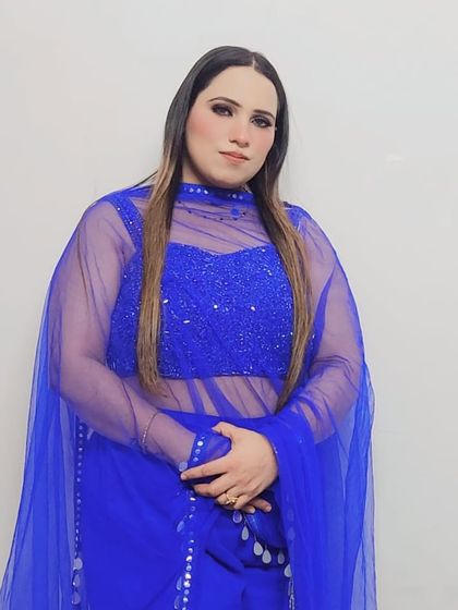 A closer look at the blouse of the royal blue set. The sheer high-neck overlay is fully embroidered with sequins, adding a touch of glamour to the outfit.