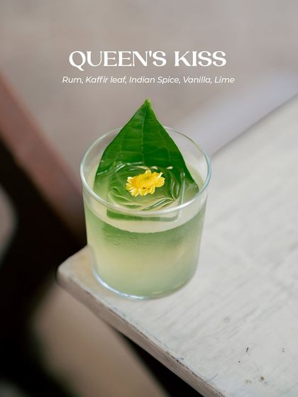 Born in the Malay peninsula, the Queen of flowers, Jasmine, floats in my crafthouse air. It lends its crown to this artisanal cocktail, the Queen's Kiss, blending with rum, kaffir lime leaf, Indian spices, and vanilla for a drink meant for regal celebrations.