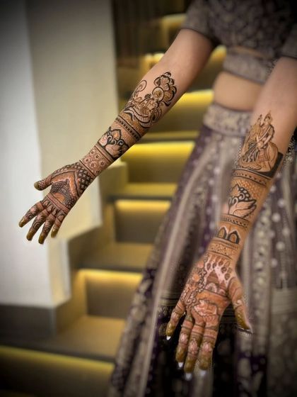 A close-up of the bride's mehandi, featuring portraits of Radha and Krishna. The design is both spiritual and beautiful.