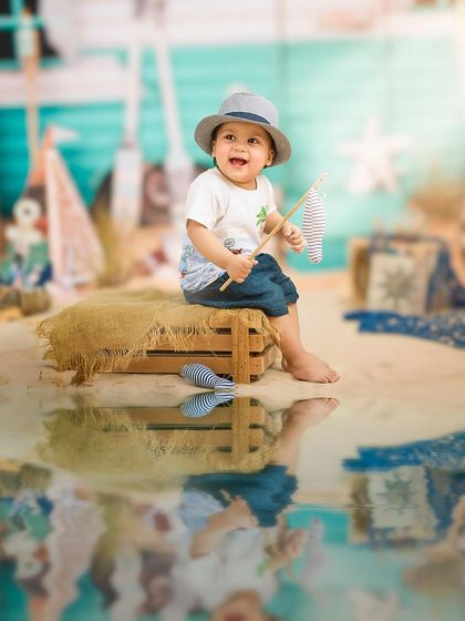 A day at the beach, right in our studio. This creative setup uses a reflective floor to simulate water, creating a fun and convincing beach scene.