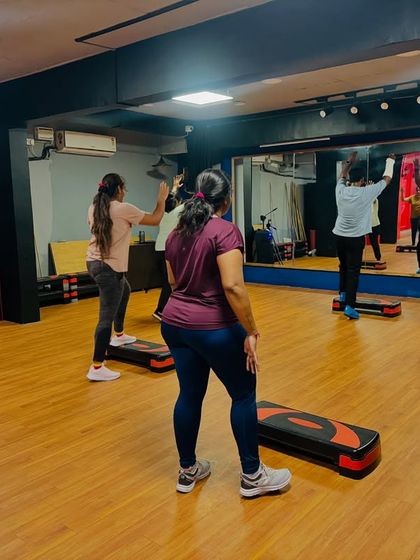 A view from the back of the class, showing everyone in sync. The large mirror helps you check your form and stay aligned with the group.