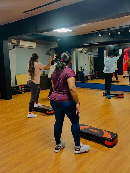 A view from the back of the class, showing everyone in sync. The large mirror helps you check your form and stay aligned with the group.