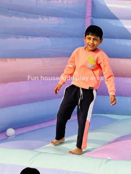 The smile says it all. A boy enjoying the bouncy floor of our pastel castle, a perfect space for kids to burn off energy.