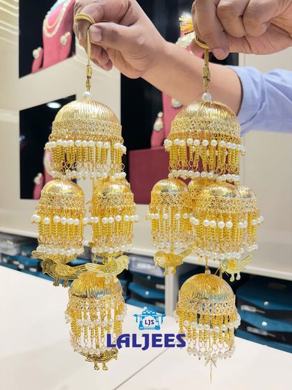 A beautiful kaleera with a mix of small and large domes, decorated with pearls.