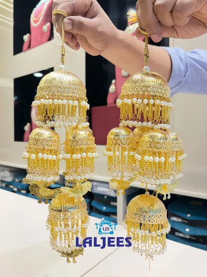A beautiful kaleera with a mix of small and large domes, decorated with pearls.