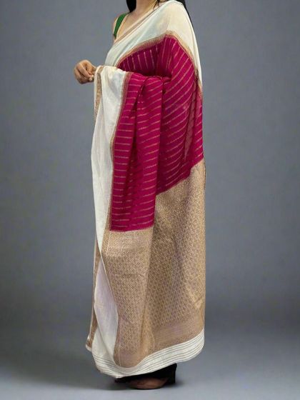 A side view of the rani pink and white semi-wrinkle crepe saree, showing the elegant drape.