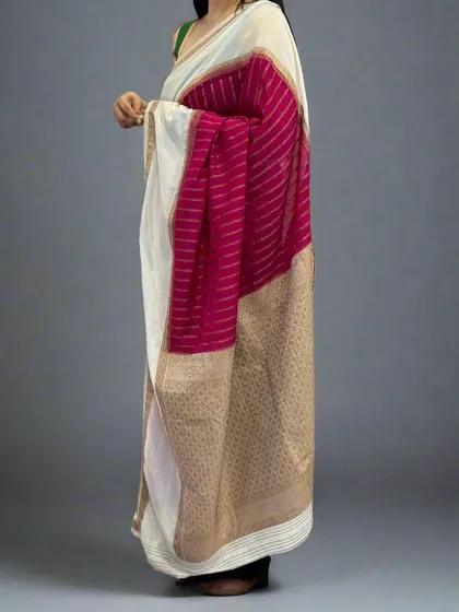 A side view of the rani pink and white semi-wrinkle crepe saree, showing the elegant drape.