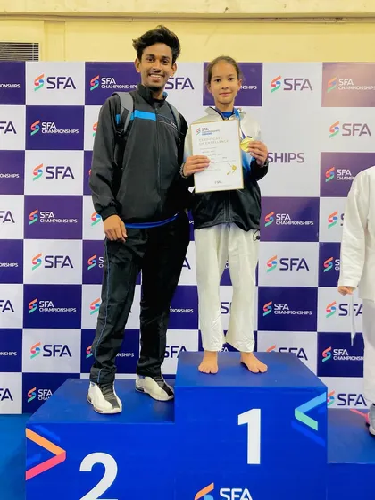 Standing with my champion, Bhavnika. Her gold medal at the SFA championship is a result of her relentless training and never-give-up attitude.