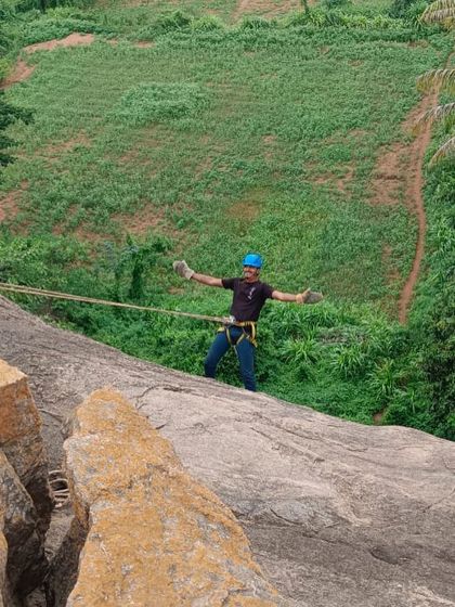 A participant enjoys the thrill of rappelling down a granite slab in Ramanagara. This activity is a favorite in our basic course, building confidence and providing a unique perspective of the landscape.