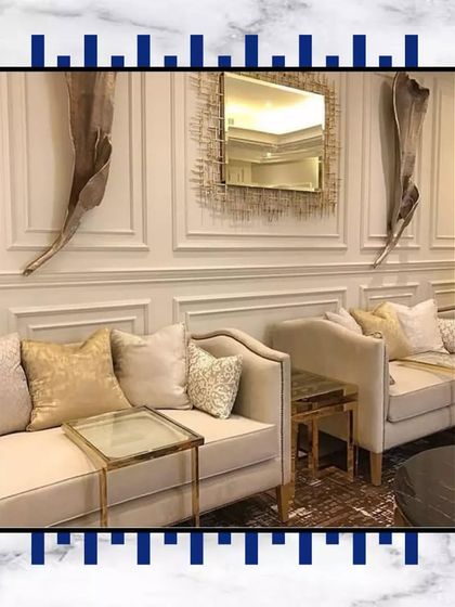 We love creating cozy yet luxurious seating areas. The combination of classic sofas, gold-accented tables, and intricate wall decor makes this a perfect spot for conversations.