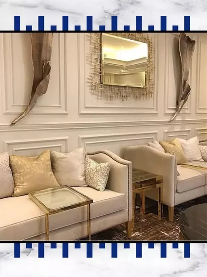 We love creating cozy yet luxurious seating areas. The combination of classic sofas, gold-accented tables, and intricate wall decor makes this a perfect spot for conversations.