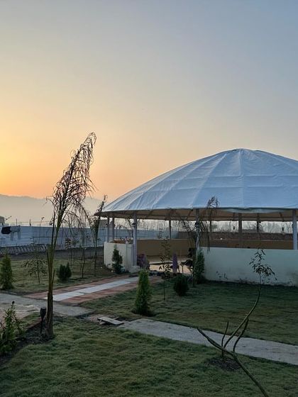The beautiful, spacious yoga shala at our new Rishikesh school, set against the backdrop of a stunning sunrise. This is where you will practice and transform.