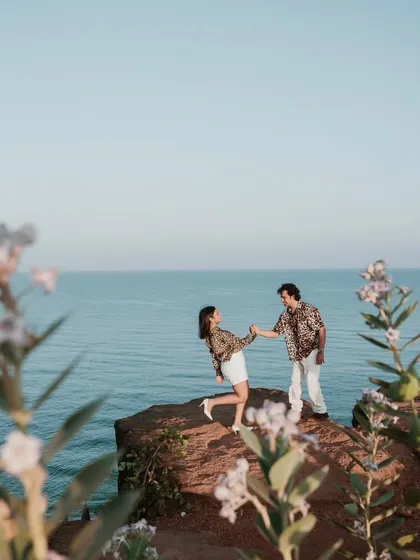 Standing on a cliff overlooking the sea in Goa, this shot captures a sense of adventure and romance. The beautiful coastal scenery provides a stunning backdrop for this destination pre-wedding photo.
