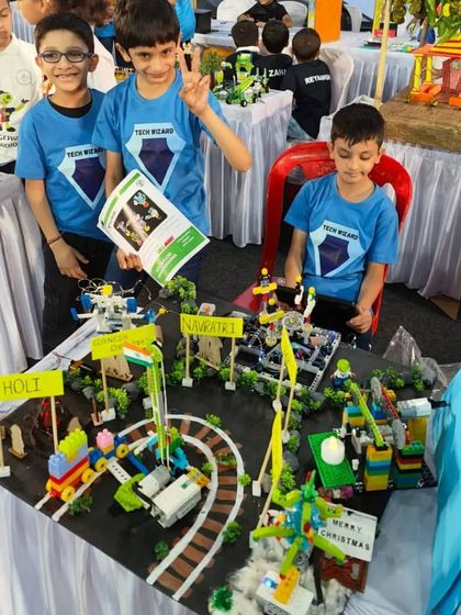 Team 'Lego Wizards' presenting their 'Festivals of India' project. This interactive model uses LEGO WeDo to showcase different cultural celebrations with moving parts and lights.