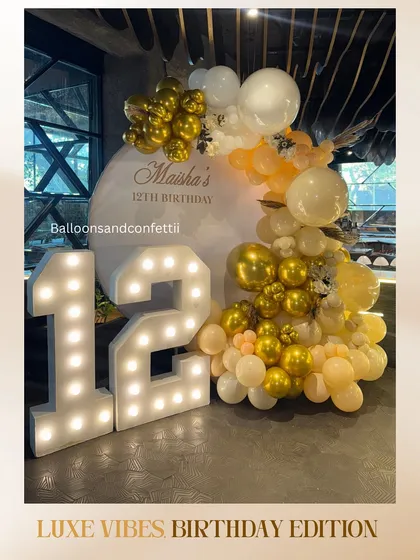 Luxe vibes for Maisha's 12th birthday. This elegant affair featured a palette of soft yellows and chrome gold, with a large marquee number and a personalized circular backdrop.