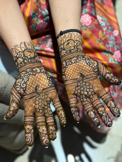 An intricate peacock design, a classic choice for any festive occasion.