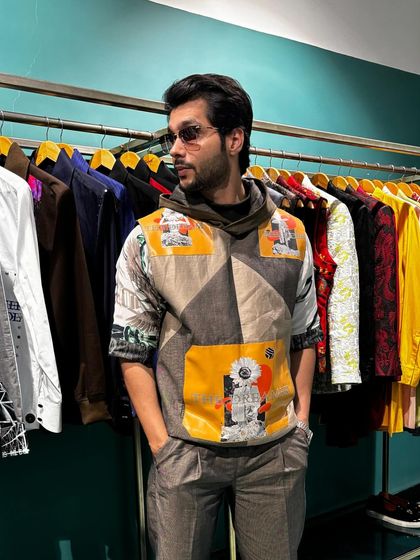 A full view of Abhishek Kumar in the Solar Flare Set, showcasing the printed Wrangler sleeve tee and embroidered trousers. This outfit offers both comfort and a standout look for any casual occasion.