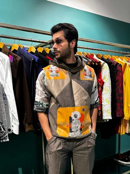 A full view of Abhishek Kumar in the Solar Flare Set, showcasing the printed Wrangler sleeve tee and embroidered trousers. This outfit offers both comfort and a standout look for any casual occasion.