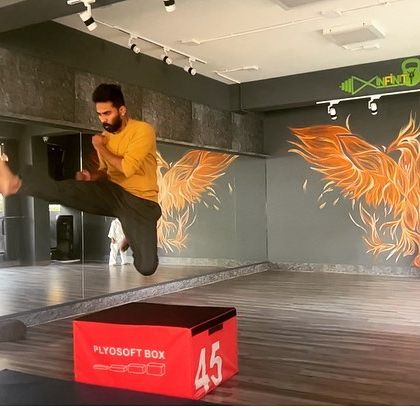 A student practices a flying side kick over a plyosoft box. Drills like these are not just about technique; they build courage and a belief in their own abilities.