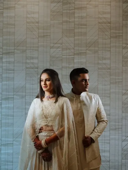 A modern and elegant portrait against a textured wall. The clean composition and the couple's confident poses result in a chic and contemporary engagement photo.