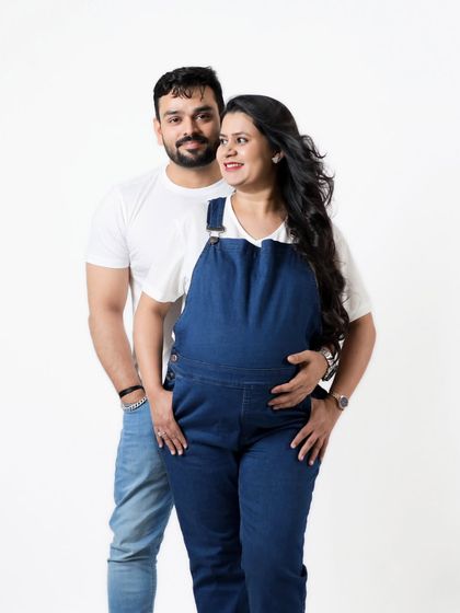 A sweet couple's portrait in matching white shirts and denim. This casual studio look is perfect for couples who want something relaxed and natural.