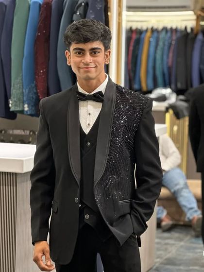 The client smiling in his chosen tuxedo, a testament to finding the perfect fit and style at our studio.