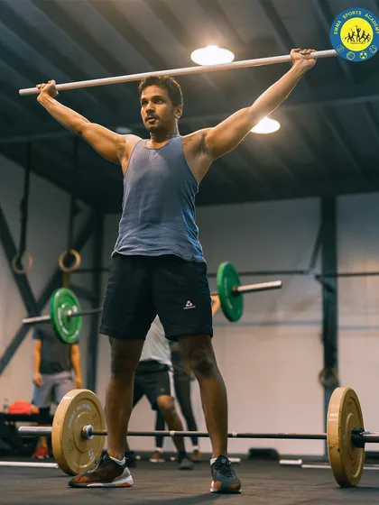 Mastering the basics is key. An athlete practices the overhead press with a light bar, focusing on form and mobility before adding weight. This is how we build a strong, injury-free foundation.