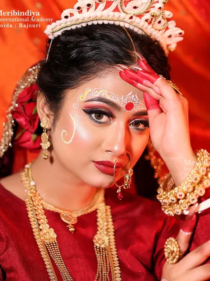 A classic portrait that captures the serene and divine essence of a Bengali bride, with a focus on the expressive eye makeup.