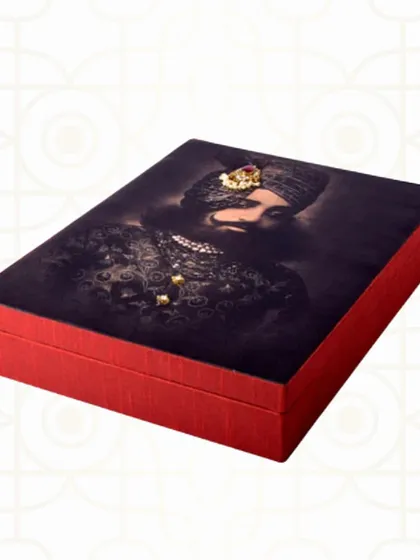This striking trousseau box features a portrait of a Maharaja, embellished with small jewels. It's a bold and regal choice for a groom's gift or as part of a royal-themed wedding.