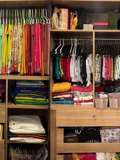 This is a great example of a fully organized ethnic wardrobe. We have hanging sarees, folded silks, and separate sections for blouses and accessories, creating a complete system.