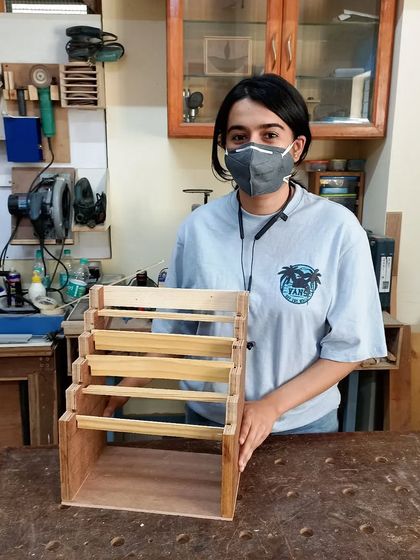 A custom-designed jewelry stand made by a student. The tiered design is perfect for organizing and displaying a large collection of jewelry.