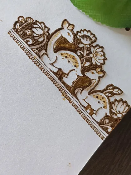 A close-up of the finished deer and lotus border, showcasing the fine details and shading.