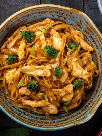Chicken and broccoli noodles in a dark sauce, shot from above for the YouMee menu.