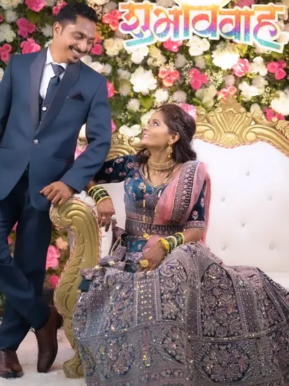 A playful and happy shot of the couple on their wedding stage.