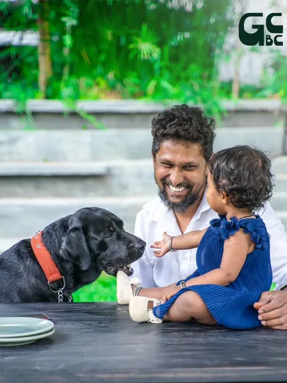 A beautiful moment between a father, his child, and their loving black labrador. These are the connections I love to foster here.