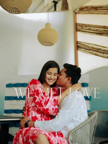 "We met love." A sweet kiss on the cheek in a beautifully decorated cafe. This single shot is full of warmth, affection, and happiness.