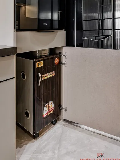 A dedicated cabinet for the flour mill (atta chakki), keeping it neatly tucked away when not in use.