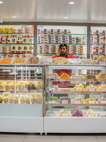 Welcome to my shop. I believe in serving you with a smile and helping you find exactly what you need. Behind this counter, you'll find everything from daily snacks to special sweets for big occasions, all fresh and ready.