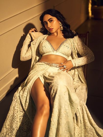 A powerful and glamorous pose from Khatija Iqbal. Her confident expression is matched by the flawless makeup and the stunning, detailed outfit.