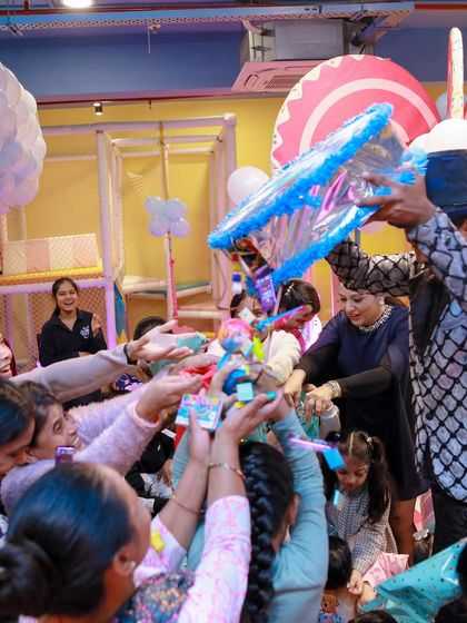 The piñata is a hit. Guests of all ages reach for the falling goodies, a classic and exciting party tradition.