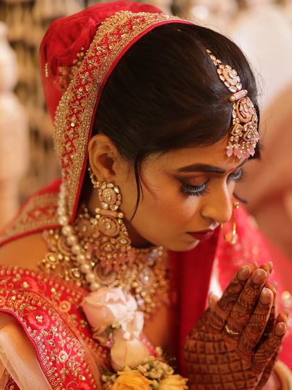 A close-up of the glamorous, glittering bridal makeup for Srishti. The bold lip and shimmery eyes are a perfect combination.