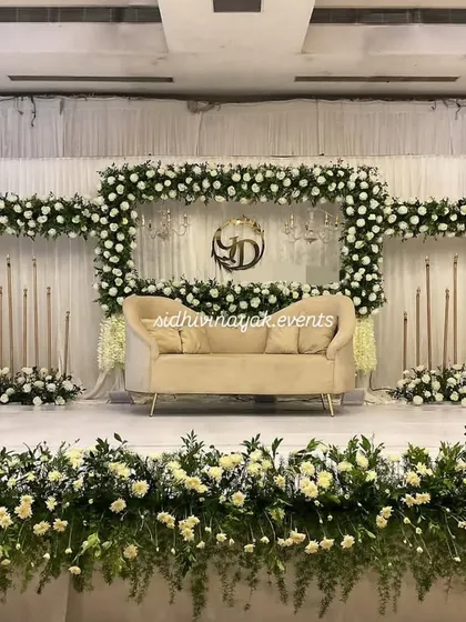For a classic and elegant look, I design stunning engagement stages like this one. The lush white floral arrangement, combined with soft lighting and a beautiful monogram, creates a sophisticated backdrop for your celebration.