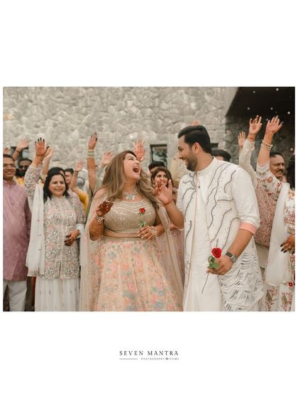 Singing and dancing their way into the celebration. This photo captures the festive spirit and energy of the couple and their guests.