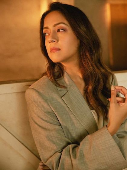 The relaxed fit of the bell-sleeved blazer is highlighted in this candid-style shot.