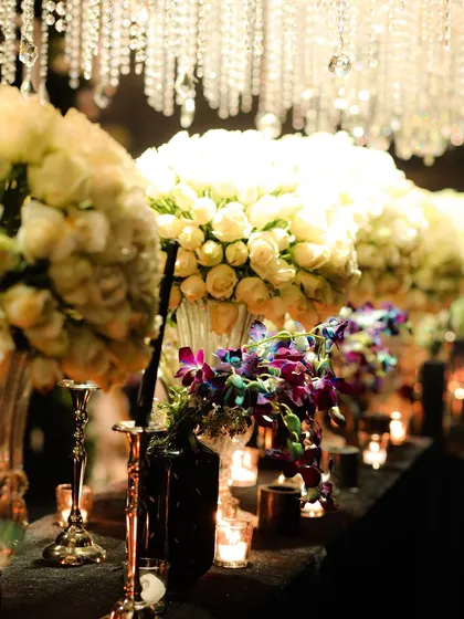 A closer view of the tablescape, showing how I introduce pops of color, like these purple orchids, into a predominantly white floral arrangement for added visual interest.