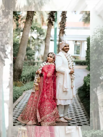 A beautiful portrait of a couple on their wedding day, standing back to back. It’s a stylish and modern take on a classic wedding pose, highlighting their stunning outfits.