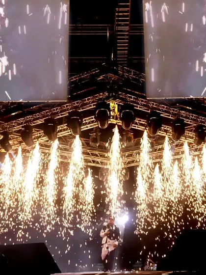 We excel at capturing peak moments, like this pyrotechnics display during a concert. This shot freezes the spectacular shower of sparks, adding to the drama of the live event.