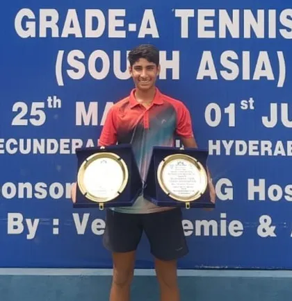 Tavish Pahwa holding his singles and doubles trophies after winning the double crown at the Under 14 Asian Grade A event in Hyderabad, a top-tier national event.