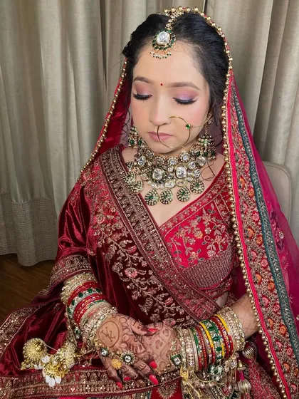 My bride Komal, looking absolutely radiant. I used soft purple and pink tones on her eyes to complement her beautiful velvet lehenga.